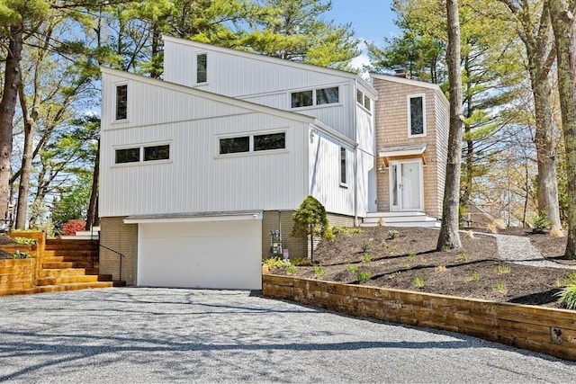 2 Cushing Lndg, Scituate, MA 02066 - view of front of house featuring a garage, driveway, and brick siding