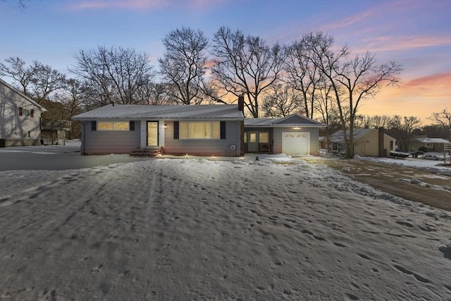 ranch-style house featuring a garage