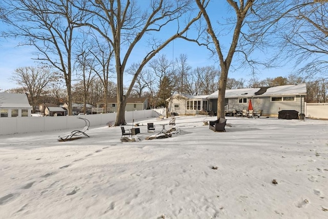 view of yard layered in snow