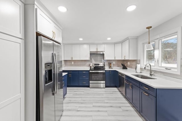 kitchen featuring blue cabinets, sink, white cabinetry, hanging light fixtures, and appliances with stainless steel finishes