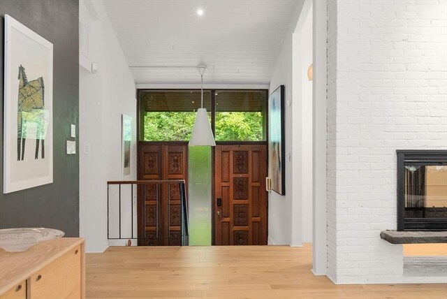 86 Myles Standish Rd, Weston, MA 02493 - entryway with a fireplace and wood finished floors