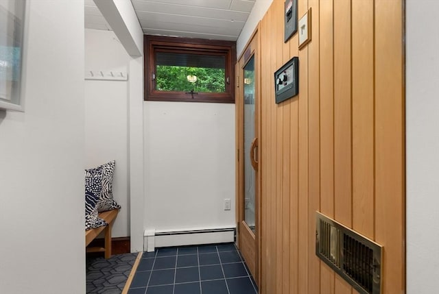 86 Myles Standish Rd, Weston, MA 02493 - entryway featuring baseboard heating, dark tile patterned floors, and wood walls