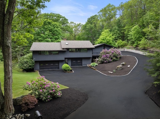 86 Myles Standish Rd, Weston, MA 02493 - view of front facade with a garage, asphalt driveway, a chimney, and a front lawn