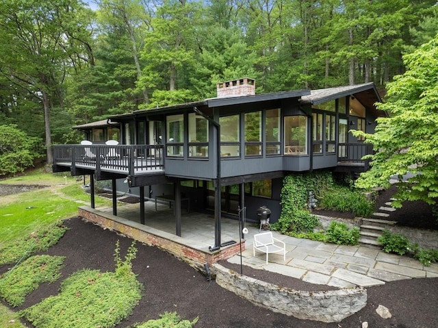 86 Myles Standish Rd, Weston, MA 02493 - back of house featuring a patio area, stairway, a sunroom, a deck, and a chimney