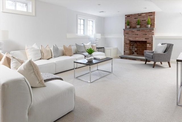 living room with a brick fireplace and light colored carpet