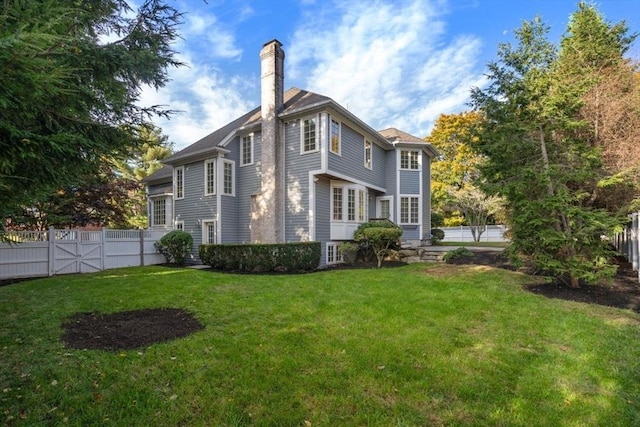 rear view of property featuring a yard