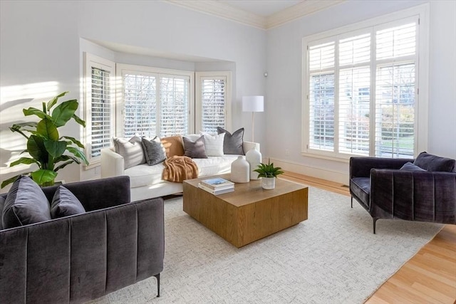 living room featuring light wood-type flooring and ornamental molding