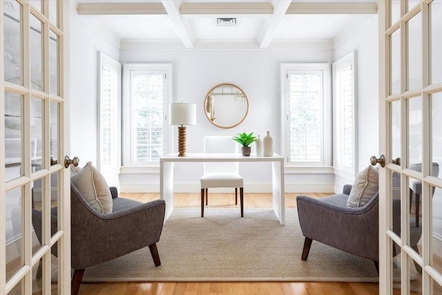 sitting room featuring a healthy amount of sunlight, french doors, hardwood / wood-style floors, beam ceiling, and coffered ceiling