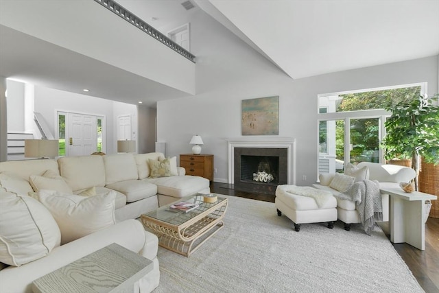 living room with high vaulted ceiling and wood-type flooring