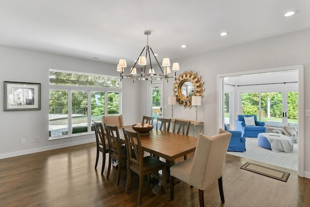 dining space with a chandelier and dark wood-type flooring