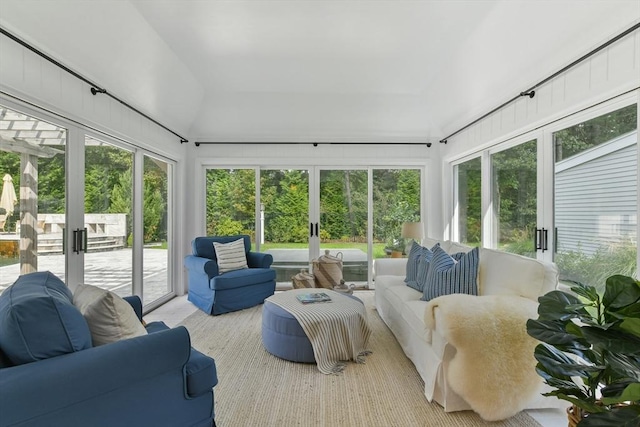 sunroom featuring lofted ceiling, french doors, and a wealth of natural light