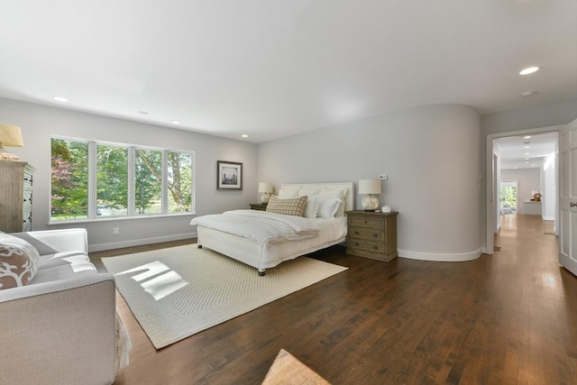 bedroom with dark hardwood / wood-style floors