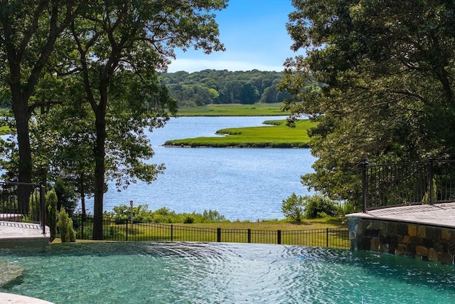 view of pool with a water view