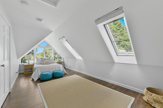 bedroom with dark hardwood / wood-style flooring and vaulted ceiling