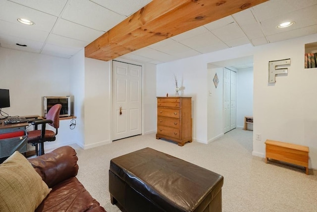 living room with carpet and a paneled ceiling