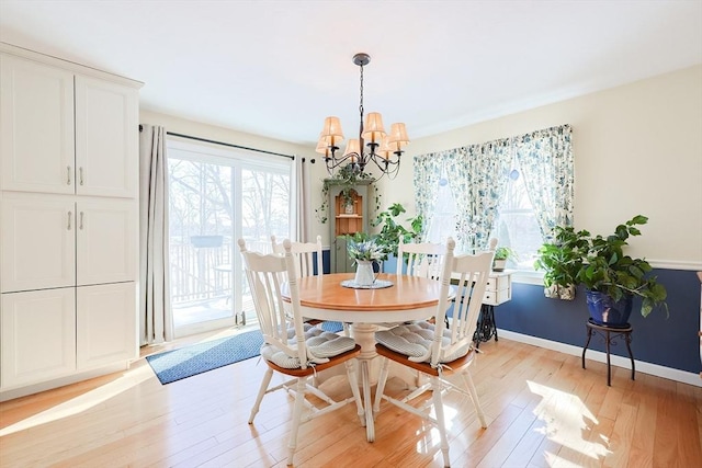 dining room featuring a notable chandelier and light hardwood / wood-style floors