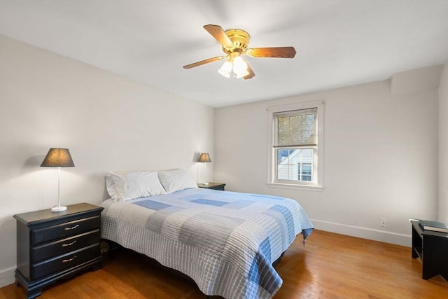 bedroom with wood-type flooring and ceiling fan