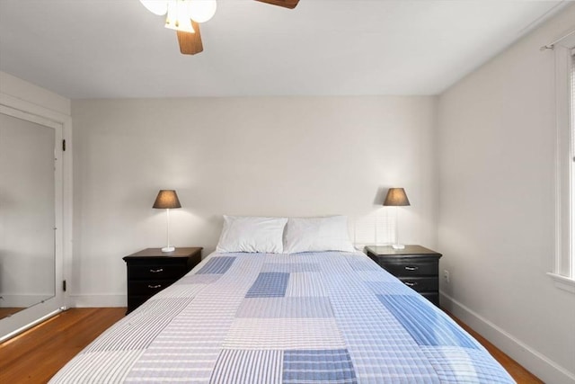 bedroom featuring ceiling fan and dark hardwood / wood-style floors