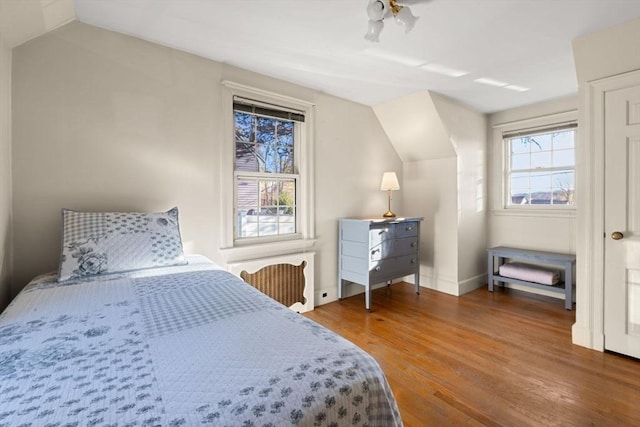 bedroom featuring vaulted ceiling and dark hardwood / wood-style floors