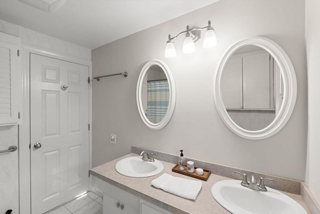 bathroom with tile patterned floors and vanity