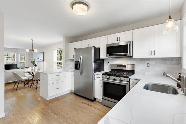 32 Pearl St Unit 32, Everett, MA 02149 - kitchen featuring stainless steel appliances, a peninsula, and white cabinetry
