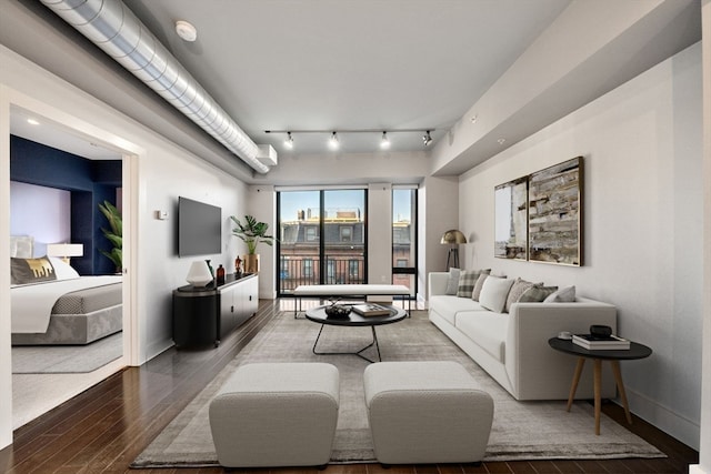 living room with wood-type flooring and track lighting