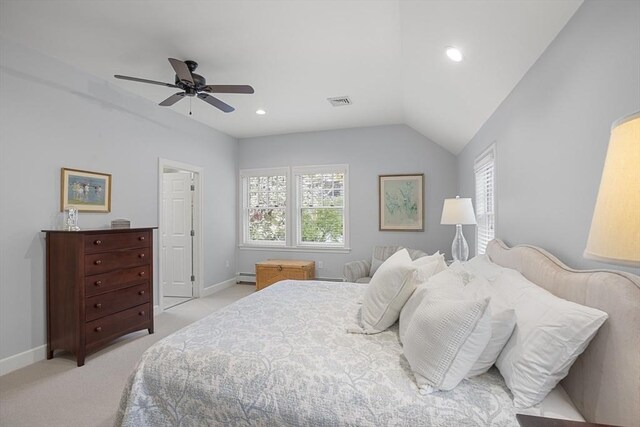 bedroom with a baseboard heating unit, multiple windows, light carpet, and baseboards