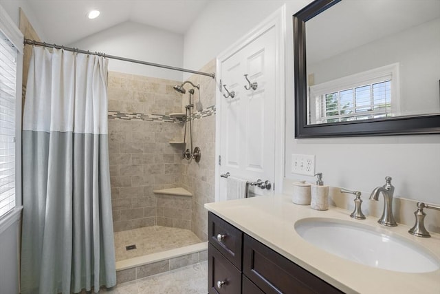 full bath featuring vanity, recessed lighting, vaulted ceiling, and tiled shower