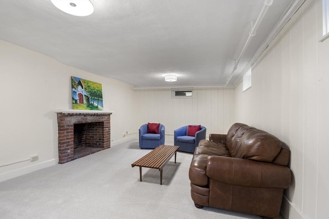 living room featuring baseboards, a fireplace, and carpet
