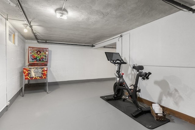 exercise area featuring a textured ceiling