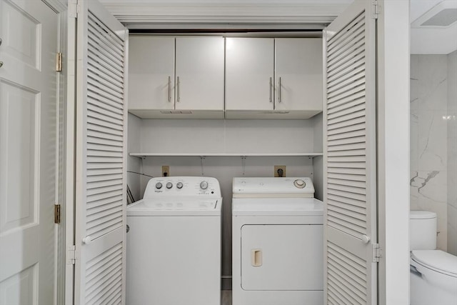 laundry room with washer and clothes dryer and tile walls