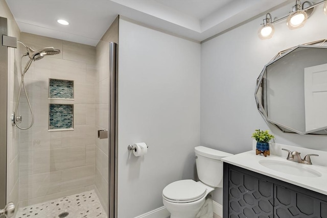 bathroom featuring an enclosed shower, vanity, and toilet