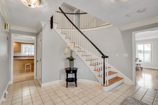 stairs with tile patterned flooring and crown molding