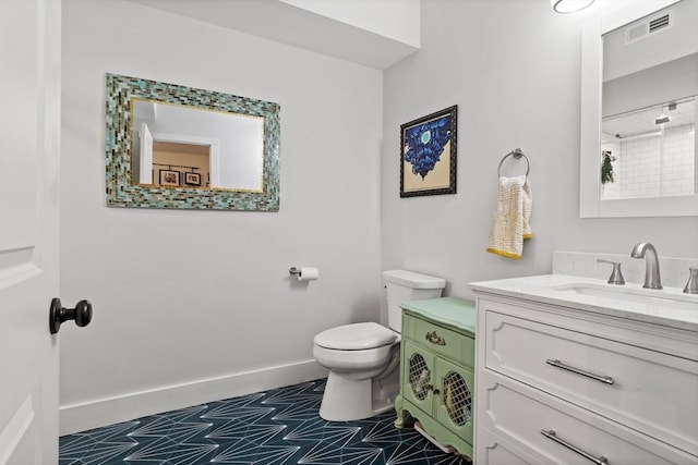 bathroom with vanity, tile patterned floors, and toilet