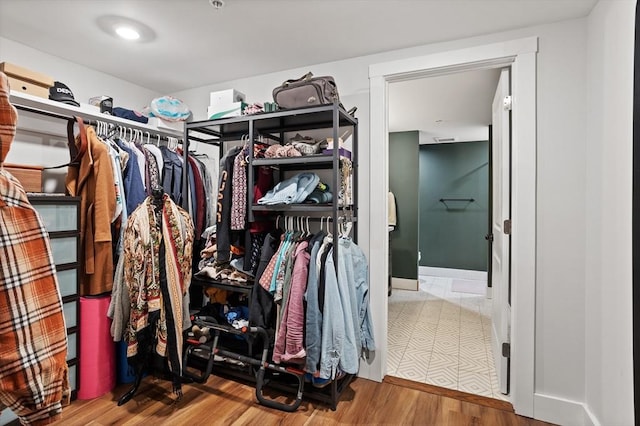 spacious closet with hardwood / wood-style flooring