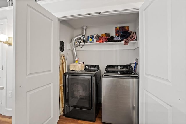 washroom featuring washer and clothes dryer and light hardwood / wood-style floors