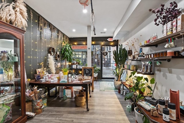 bar with hardwood / wood-style floors