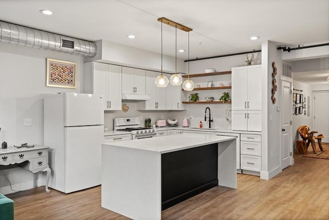 kitchen with sink, white appliances, white cabinetry, hanging light fixtures, and a center island