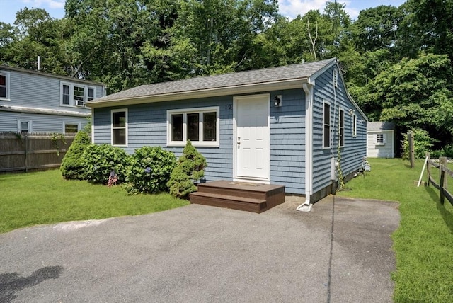 12 Day St, Fairhaven, MA 02719 - view of front of property featuring roof with shingles, view of wooded area, and a patio area