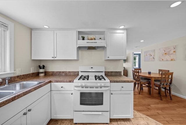 12 Day St, Fairhaven, MA 02719 - kitchen featuring white gas stove, under cabinet range hood, white cabinets, recessed lighting, and open shelves