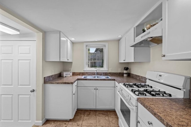 12 Day St, Fairhaven, MA 02719 - kitchen featuring white range with gas stovetop, under cabinet range hood, dark countertops, white cabinetry, and recessed lighting