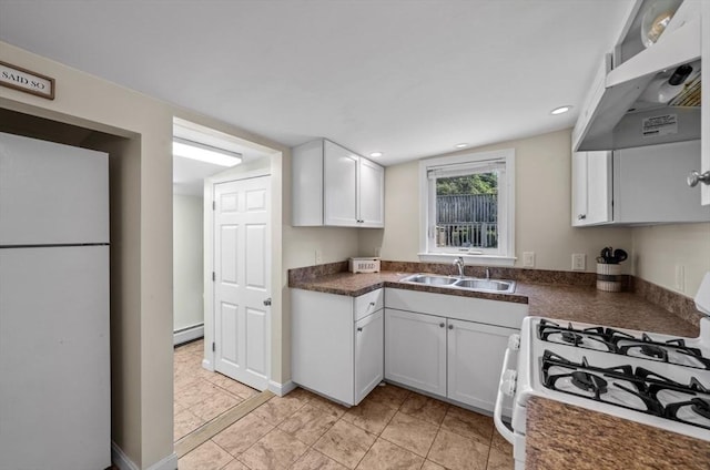 12 Day St, Fairhaven, MA 02719 - kitchen featuring white appliances, wall chimney range hood, dark countertops, white cabinetry, and recessed lighting