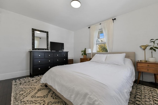 bedroom with dark hardwood / wood-style floors