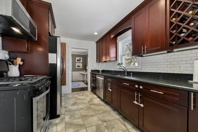 kitchen featuring crown molding, appliances with stainless steel finishes, sink, and decorative backsplash