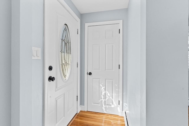 entryway featuring a baseboard radiator and light wood-style flooring