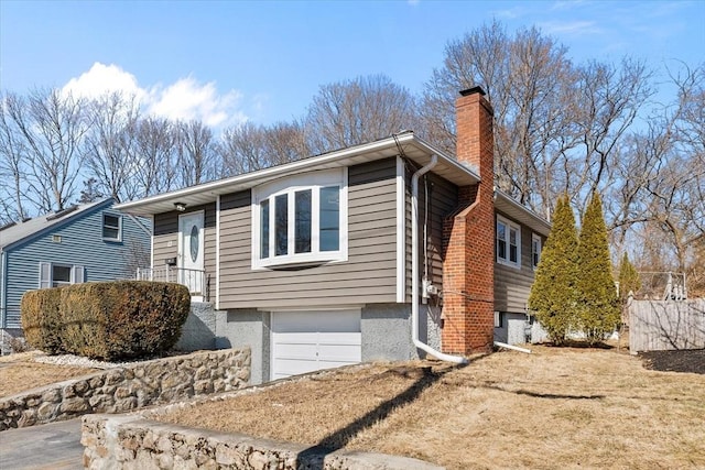 single story home featuring a garage and a chimney