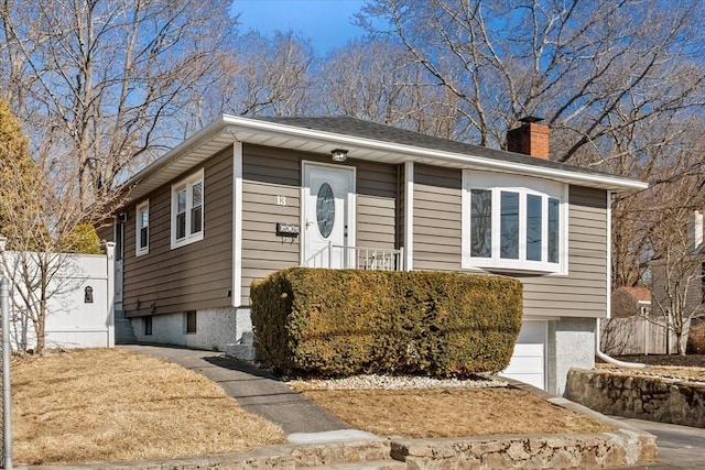 view of front of house featuring a chimney and fence