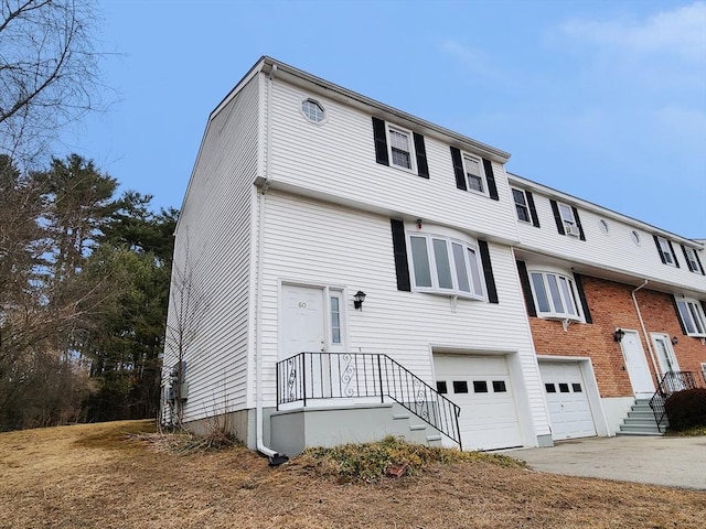 multi unit property with concrete driveway and an attached garage