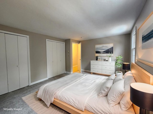 bedroom featuring multiple closets, light colored carpet, and baseboards