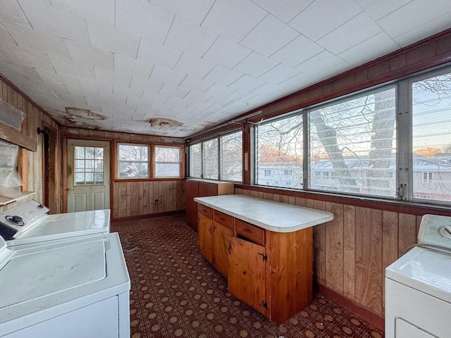 laundry area with washer and clothes dryer and wood walls